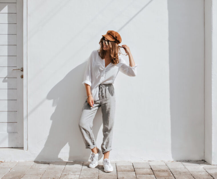 Make Your own clothing line. Stylish girl in design gray pants and white cotton blouse