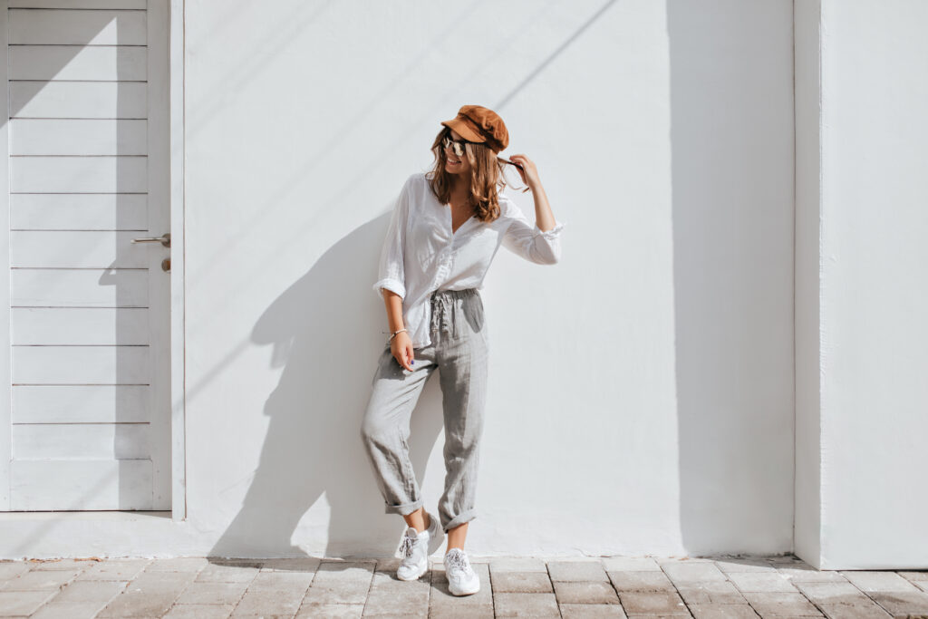 Make Your own clothing line. Stylish girl in design gray pants and white cotton blouse