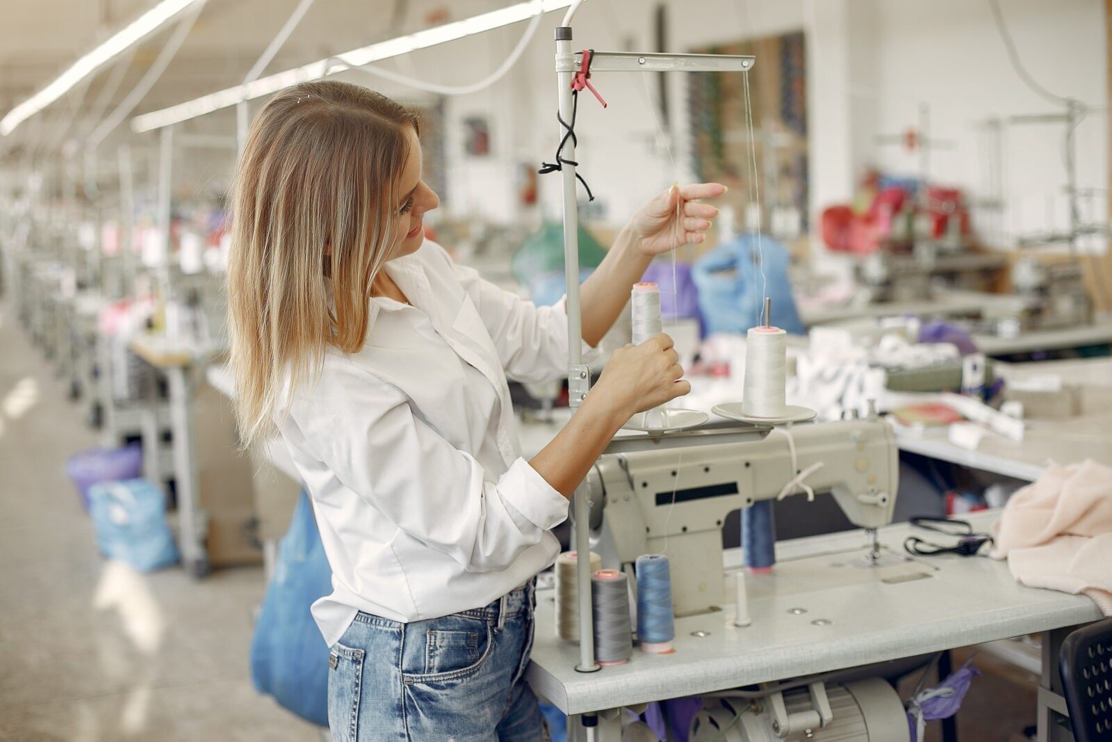 Woman with a thread. Lady in the factory.